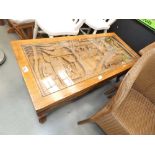Heavily carved South East Asian coffee table with glazed insert