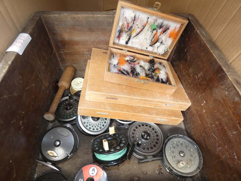 A box containing fly boxes and reels