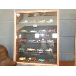 Quantity of die cast cars in display case