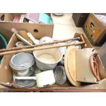 A box containing enamelled cooking pots, two walkingsticks and a chopping board