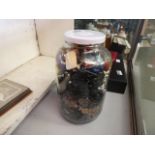 (Lot 5577 2037). A glass bottle with a quantity of buttons