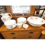 Floral patterned washstand, jug and bowl set plus two chamber pots
