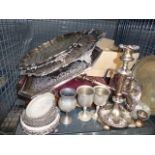 A cage containing: loose cutlery, cutlery canteen, silver plated trays, goblets and candlesticks