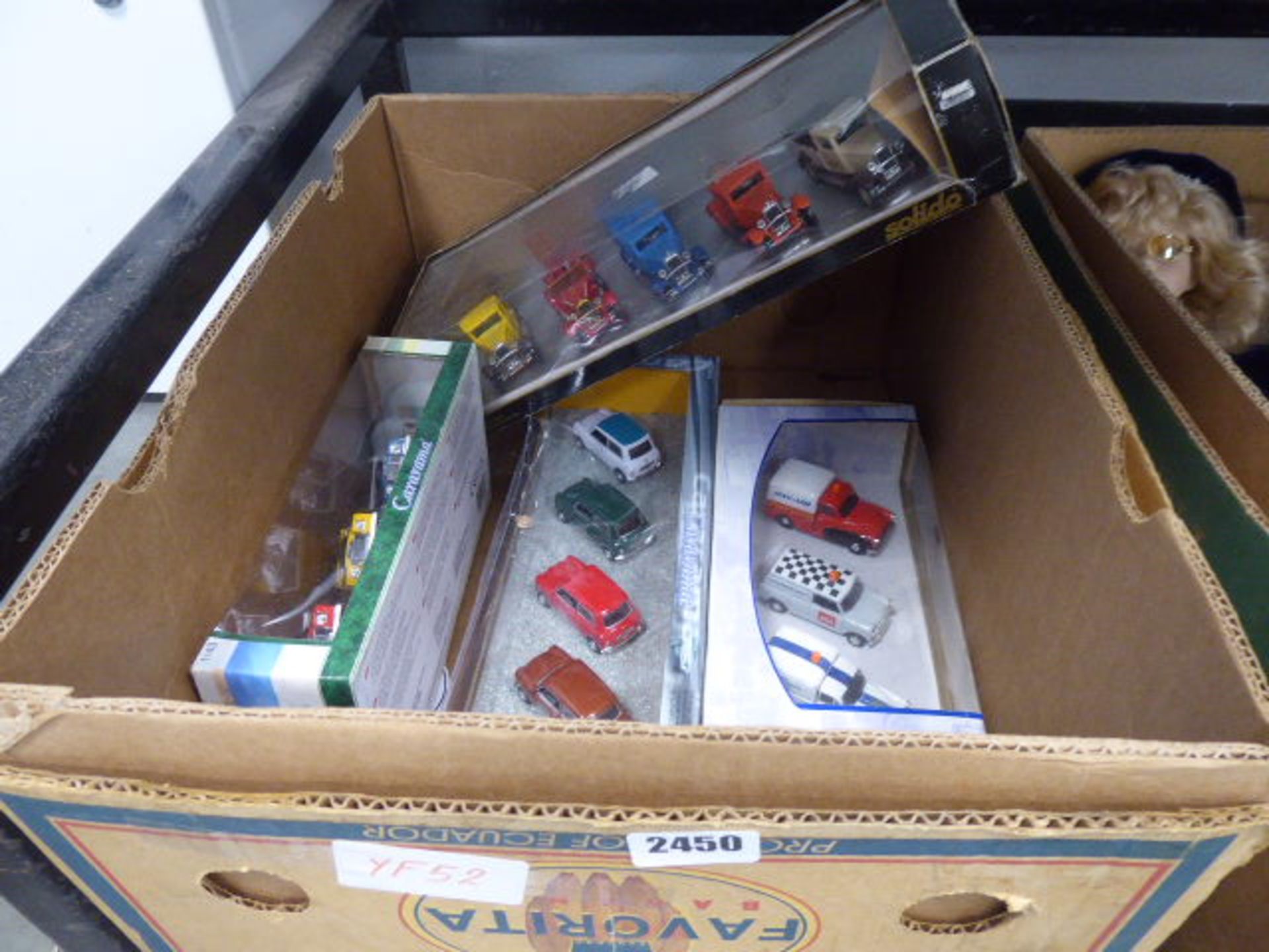 Box containing various sets of die cast vehicles