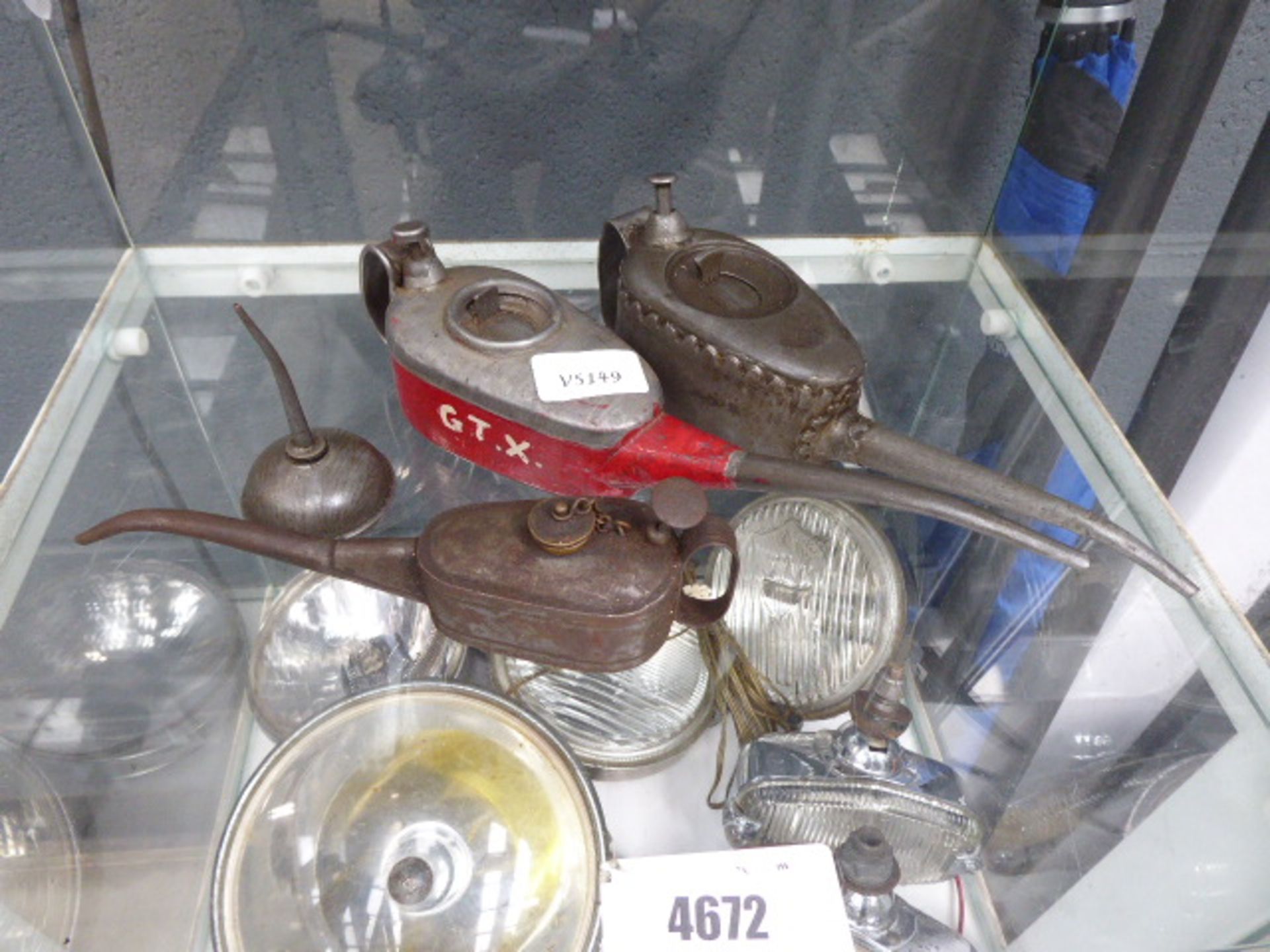 Shelf of vintage oil cans