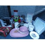 Cage containing candle pots, soup bowl and plate, coffee mugs, puzzles, kitchen storage vessels