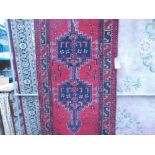 6) Woollen Iranian mat with blue central medallions and red background