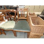 A pair of 1920's oak dining chairs, with green fabric seats
