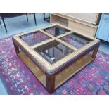 A darkwood two tier coffee table with glazed panels