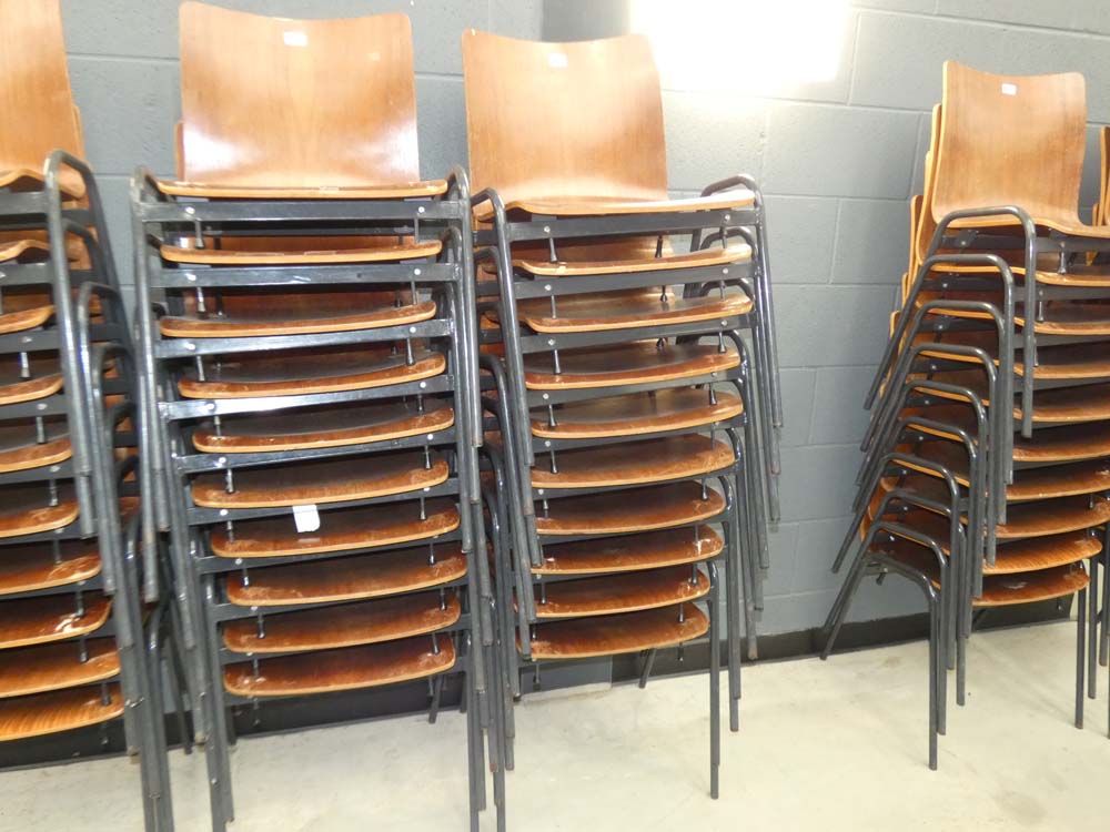 Stack of 10 bent wood chairs on metal frames