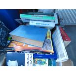 Box containing reference books and novels