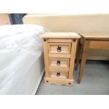 A pair of rustic pine three drawer bedside cabinets