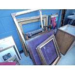 Stack of picture frames and a folding table plus a fire guard