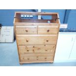 A pine baby changer with drawers under