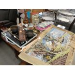 Table top of collectible items to include tapestry, prints, lamp bases, brass scales, trays, tins,