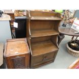 An ercol open fronted bookcase with cupboard under