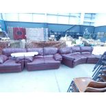 A maroon leather effect sofa, to include a two seater armchair and a bow fronted four seater