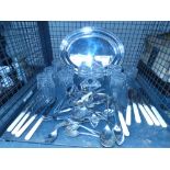 Cage containing various silver plated cutlery, silver plated serving platter and a set of 10 crystal