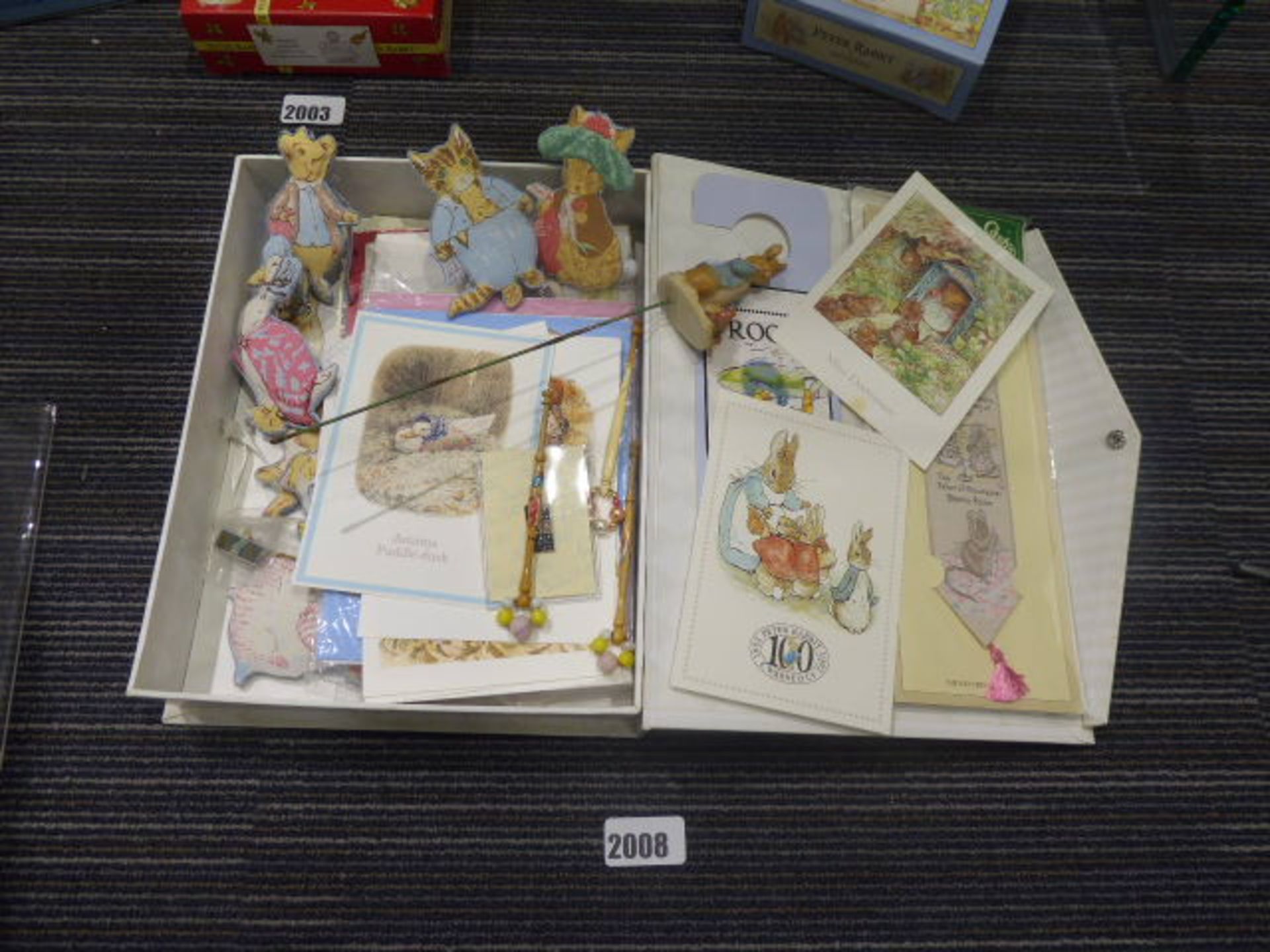 Tray containing various Beatrix Potter collectable badges, fabric figures, bobbins, postcards,
