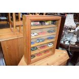 Glazed pine display cabinet with a quantity of die cast cars