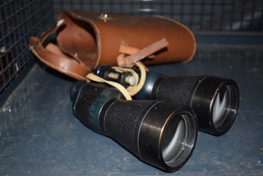 Cage containing a pair of binoculars