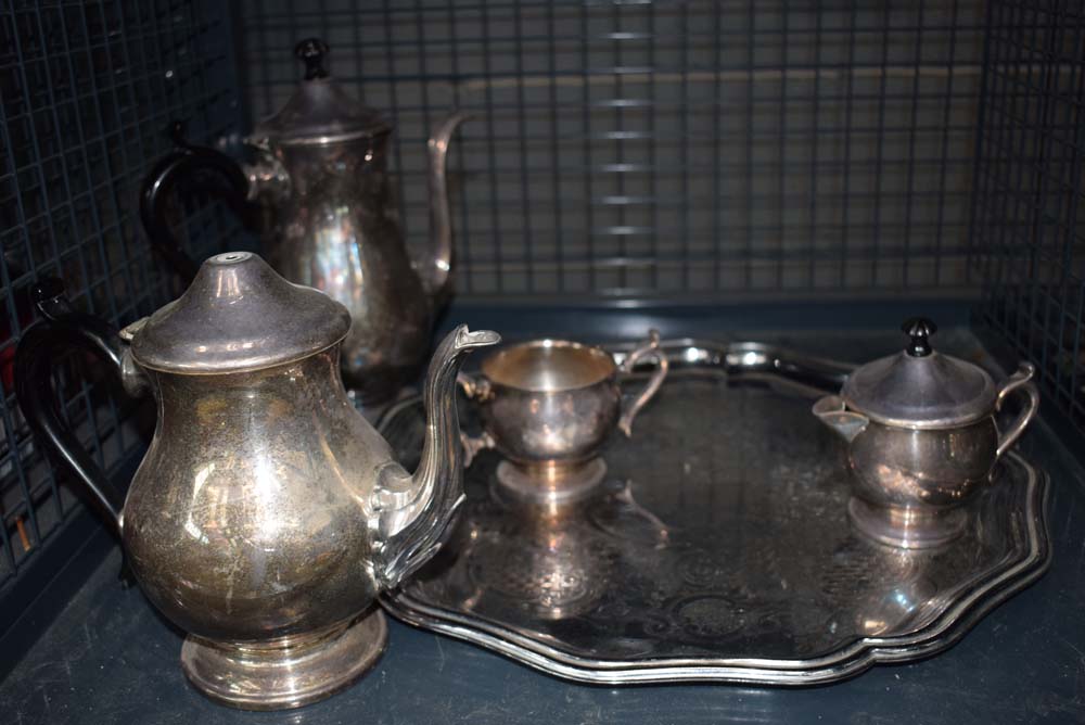 Cage containing silver plated serving tray and a tea service