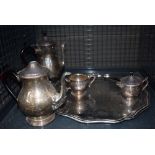 Cage containing silver plated serving tray and a tea service