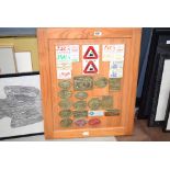 Quantity of brass and other steam train fair plaques on a pine backing board
