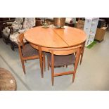 Circular teak extending dining table with 4 matching chairs