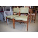 Pair of teak framed dining chairs with green rexine seating *Collector's Item: Sold in accordance
