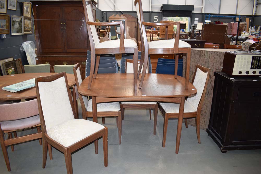 Oval teak extending dining table with 6 teak framed chairs with silver gilt floral decorated