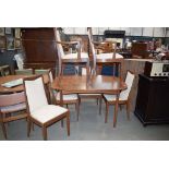 Oval teak extending dining table with 6 teak framed chairs with silver gilt floral decorated