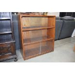 5233 Walnut bookcase in 3 sections with glazed sliding doors