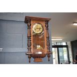 Brass wall clock in walnut case