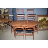 Oval teak extending table with 6 teak framed chairs with black rexine seating, probably G-Plan *