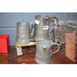 3 pewter measuring jugs plus a brass trivet