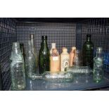 Cage containing ginger beer bottles and glass bottles