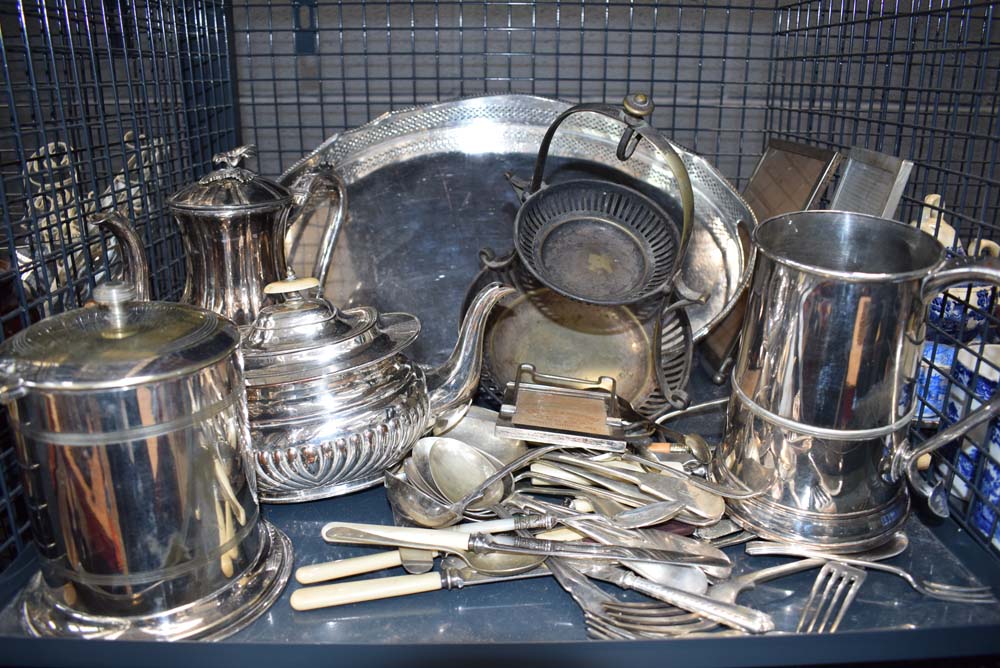 5618 Cage and box containing silver plate to include a galleried tray, teapots, an ale mug,