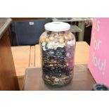 Glass jar of assorted buttons
