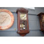Brass wall clock in stained beech case