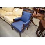Carved wooden armchair in blue rexine