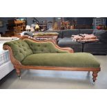 Carved Victorian chaise longue with green fabric