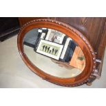 Oval bevelled mirror in mahogany frame