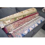 3 floral carpets in pink, blue, maroon and beige