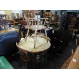 Pine circular kitchen table and set of 3 spindle back chairs