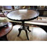 Mahogany oval occasional table with pie crust edge and single pedestal support