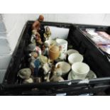 Crate of various decorative china figures, jugs, cups, etc.