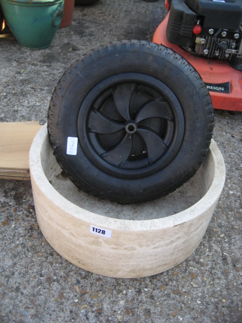 Planter with spare wheel barrow wheel