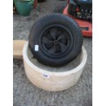 Planter with spare wheel barrow wheel