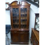 Mahogany effect glass fronted bookcase with cupboards below